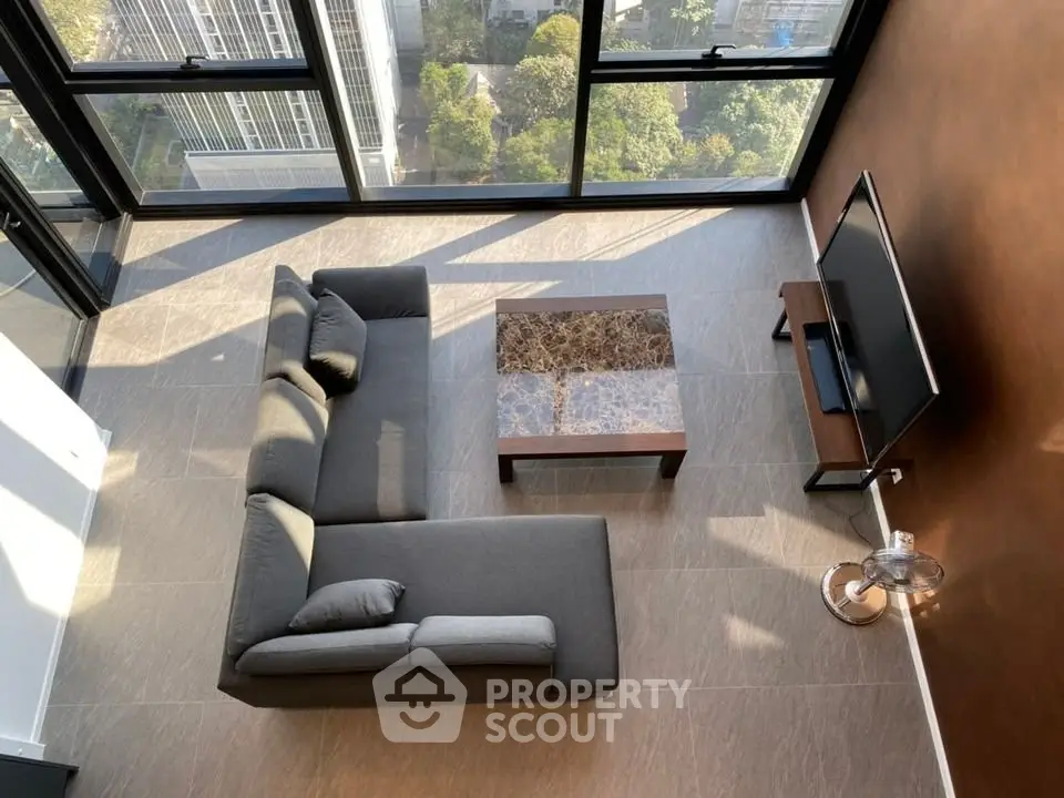 Modern living room with floor-to-ceiling windows and stylish furniture
