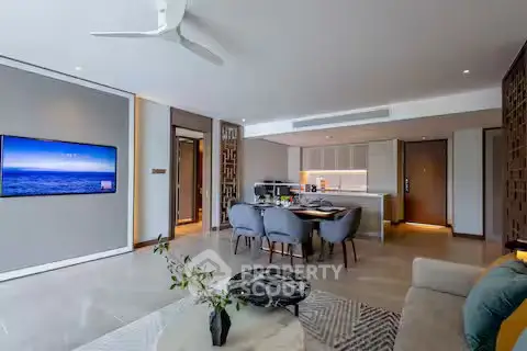 Modern open-plan living room and kitchen with stylish decor and ambient lighting.