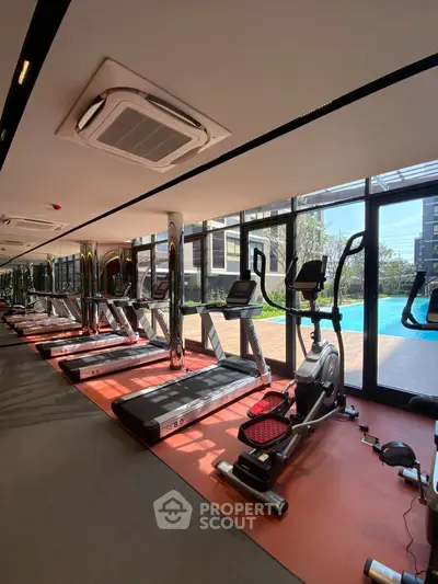 Modern gym with pool view in luxury real estate property