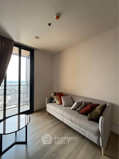 Modern living room with cozy sofa and balcony view in stylish apartment