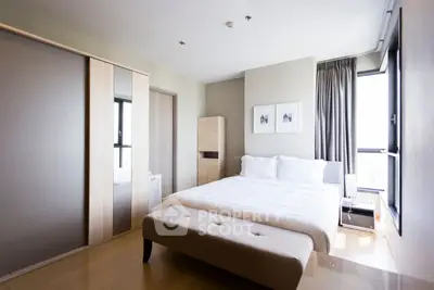 Spacious modern bedroom with large windows and stylish decor