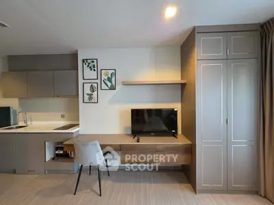 Modern living room with sleek furniture and integrated kitchen, perfect for urban living.