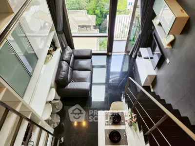 Modern loft apartment with sleek black flooring and stylish balcony view