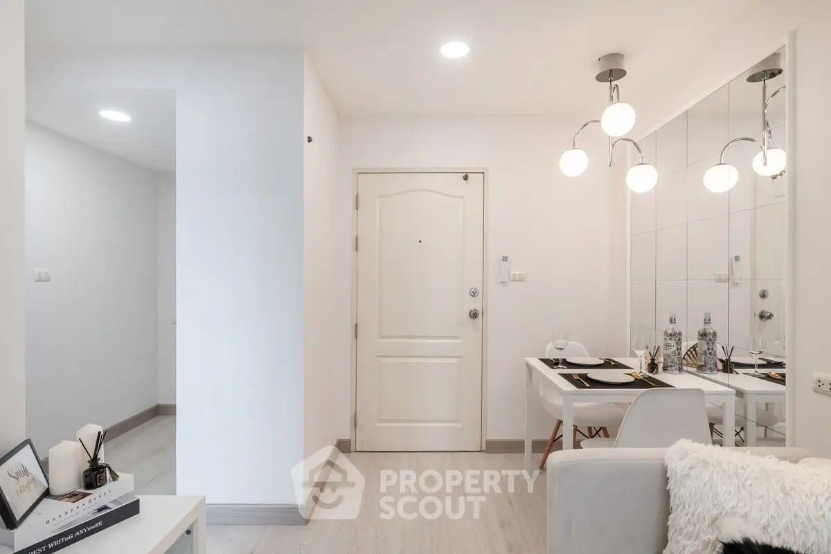 Modern apartment entrance with dining area and stylish lighting