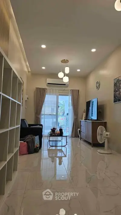 Spacious living room with modern decor and large windows for natural light.