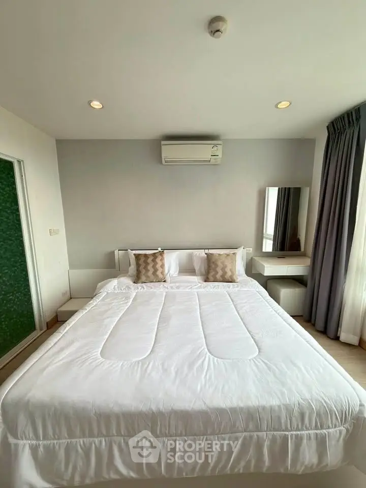 Spacious bedroom with modern decor and natural light