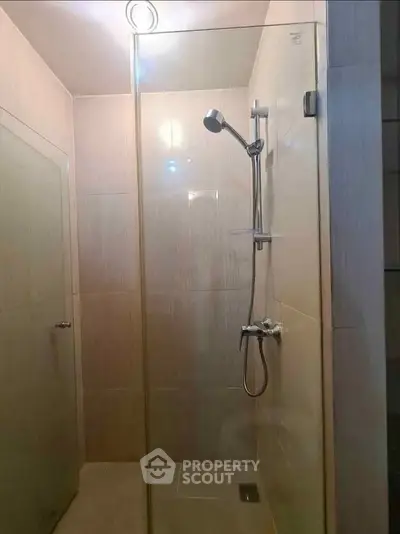 Modern bathroom with glass shower enclosure and sleek fixtures