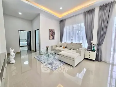 Spacious modern living room with elegant decor and large windows.