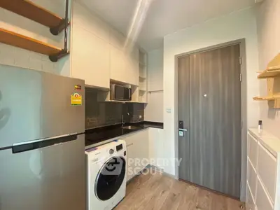 Modern kitchen with sleek appliances and wooden accents