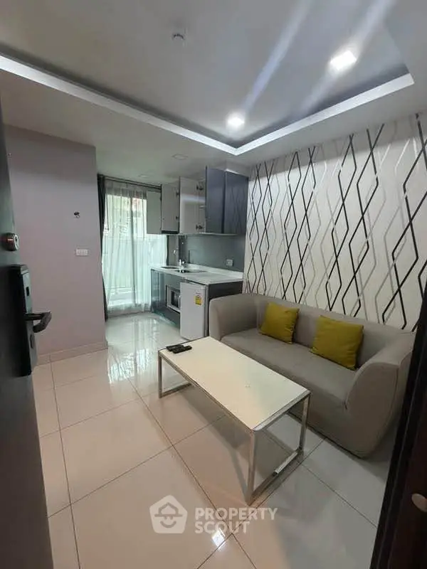 Modern living room with stylish decor and open kitchen layout in a cozy apartment.