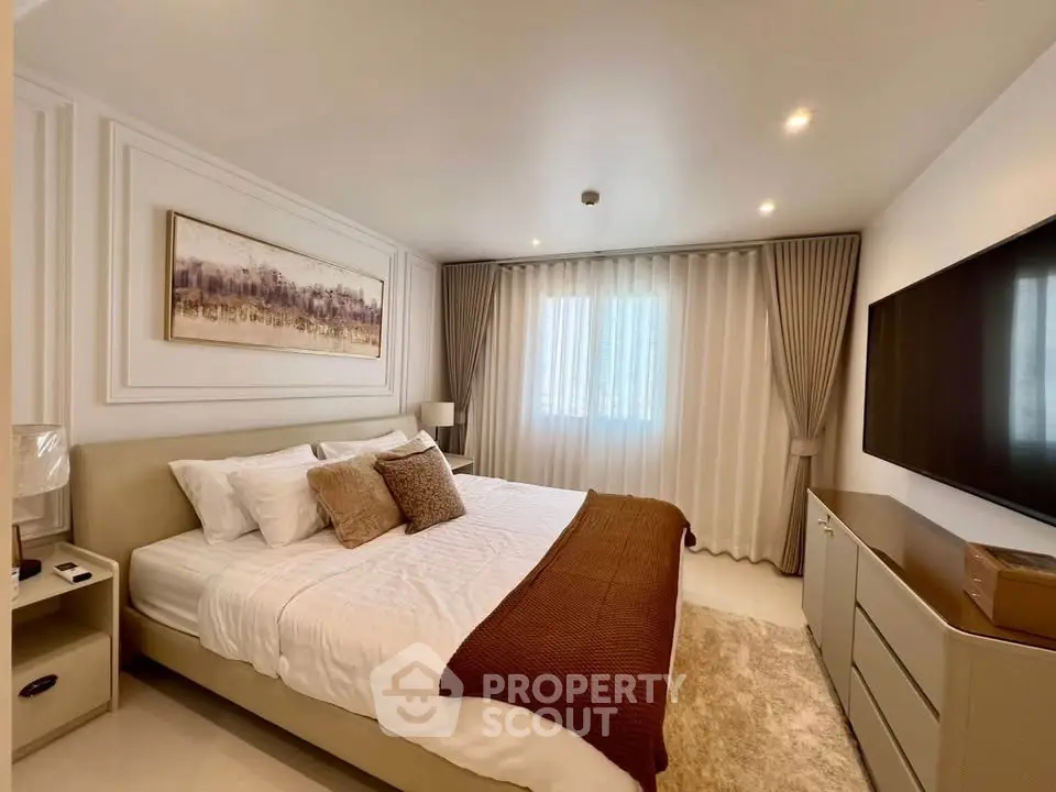 Luxurious bedroom with elegant decor and large window, perfect for relaxation.