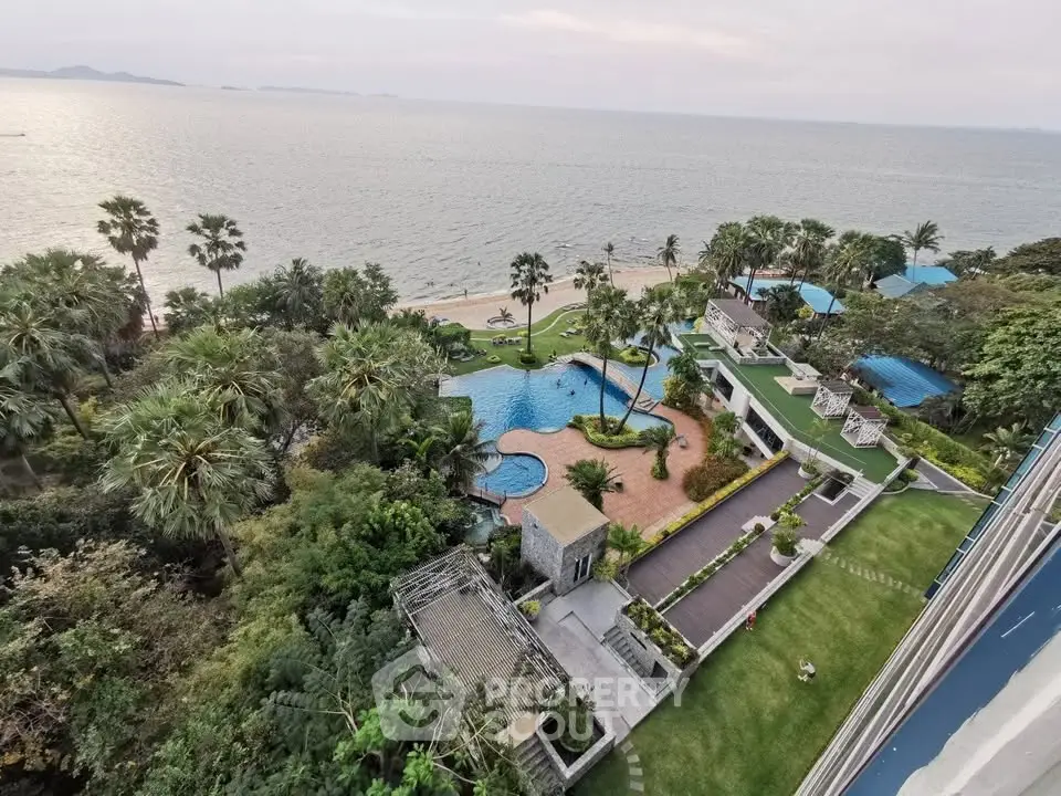 Stunning beachfront property with lush gardens and a sparkling pool offering breathtaking ocean views.
