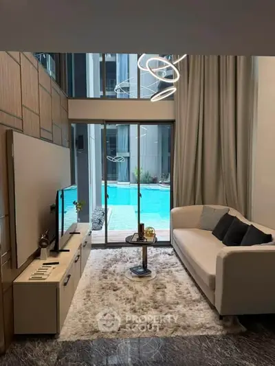 Luxurious living room with pool view, modern decor, and elegant lighting in a high-end apartment.