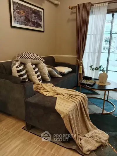 Cozy living room with stylish sofa, elegant curtains, and chic decor for a welcoming ambiance.