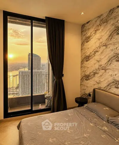 Luxurious bedroom with stunning sunset city view from large window, elegant decor and cozy ambiance.