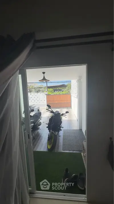 Stylish balcony with ocean view and motorcycle parking, perfect for modern living.