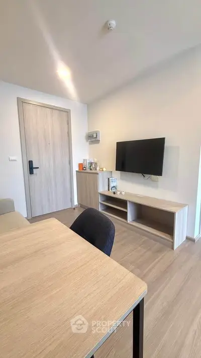 Modern living room with sleek wooden furniture and wall-mounted TV