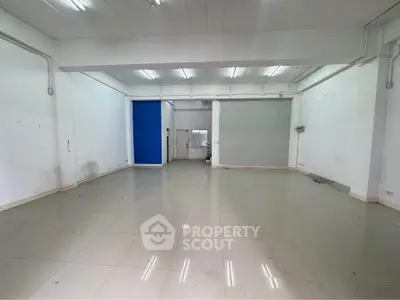 Spacious empty room with tiled flooring and white walls, ideal for customization.