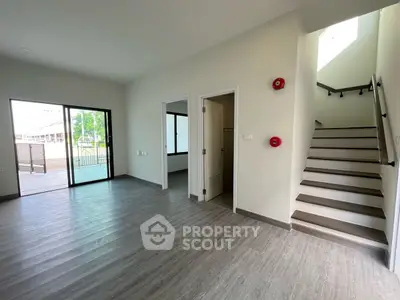 Spacious modern living room with staircase and balcony access