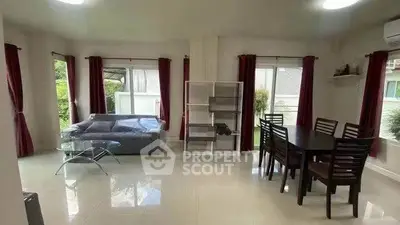 Spacious living room with modern furniture and large windows for natural light.