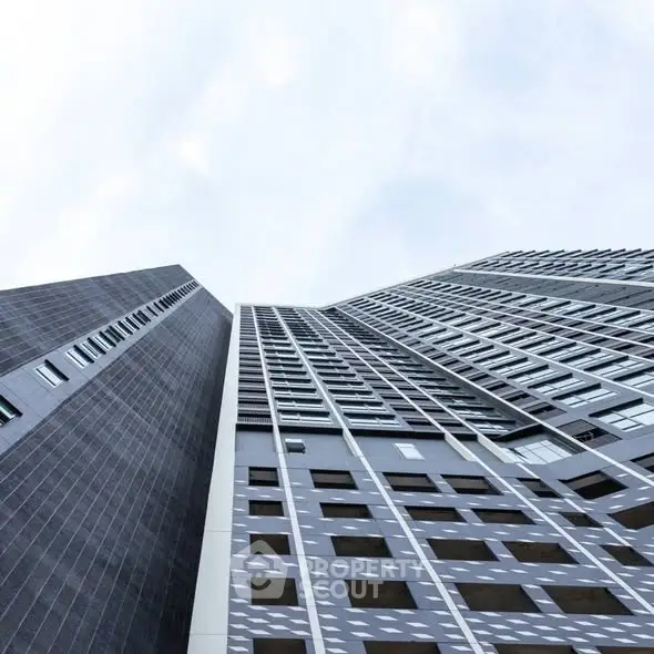 Modern high-rise building with sleek architectural design and glass facade.