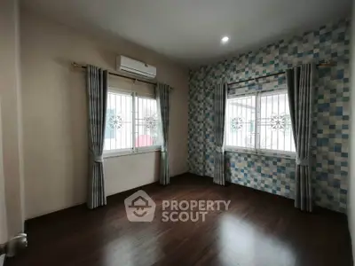 Spacious room with elegant curtains and modern air conditioning unit