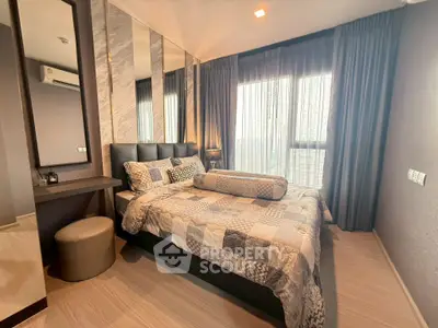 Modern bedroom with stylish decor and large windows in a contemporary apartment.