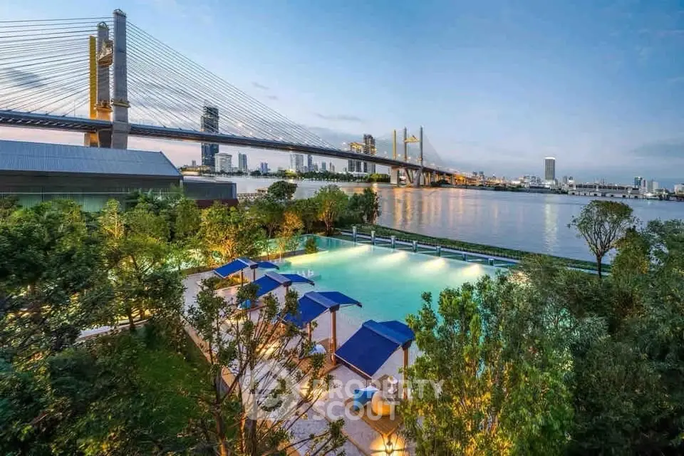 Luxurious riverside pool with stunning bridge view, perfect for relaxation and leisure.