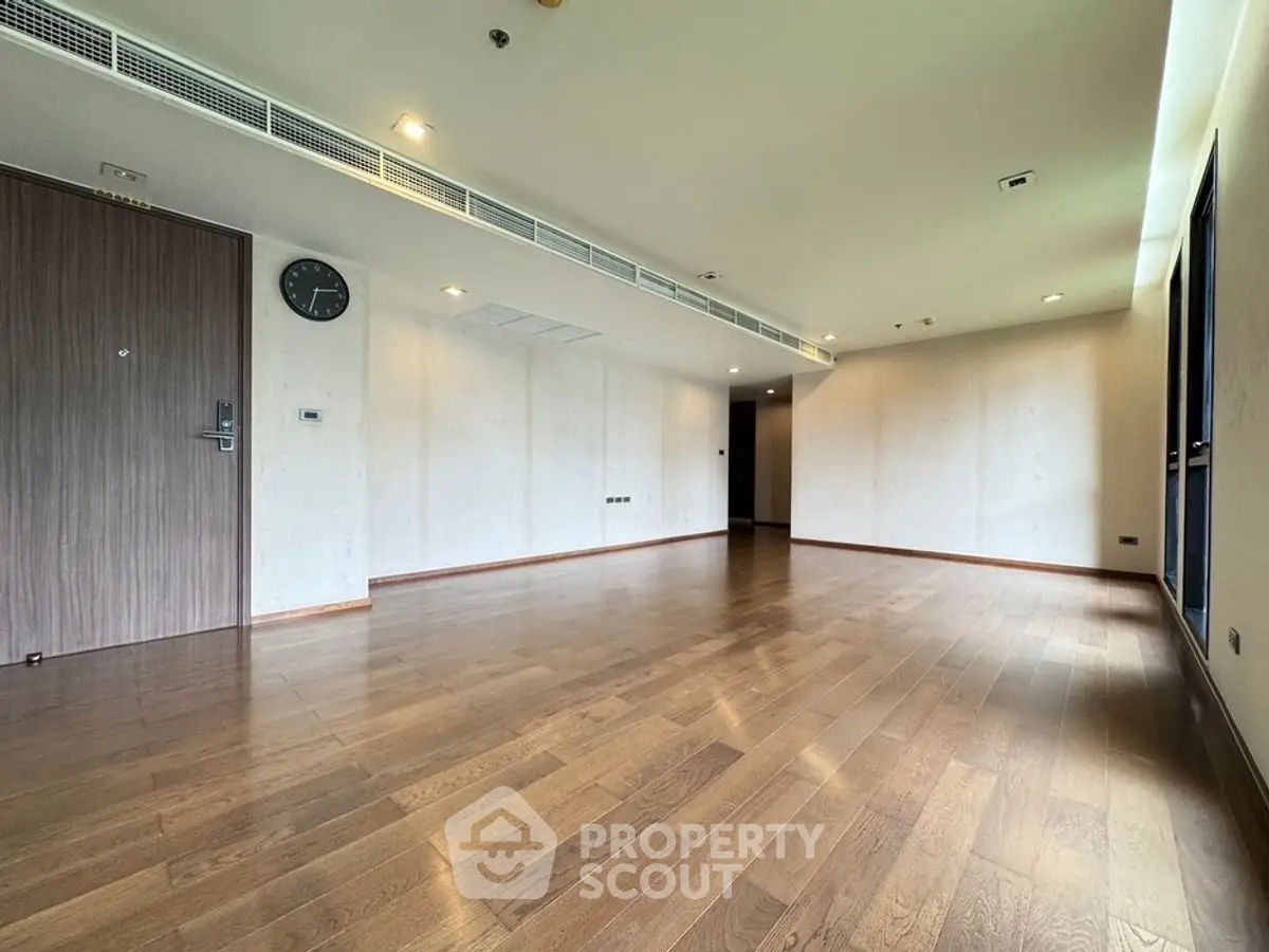 Spacious empty living room with wooden flooring and modern design