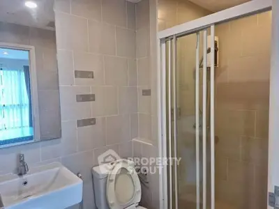 Modern bathroom with shower and toilet in sleek apartment