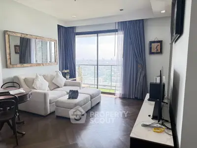 Elegant living room with city view, featuring cozy sofa, stylish decor, and large window for natural light.