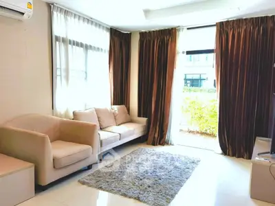 Bright and cozy living room with plush seating and large windows in modern home