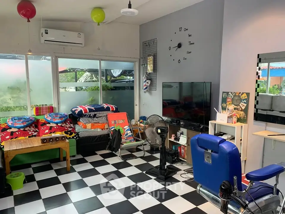Charming living room with checkered floor, colorful decor, and modern amenities.