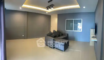 Spacious modern living room with sleek gray sofa and stylish lighting