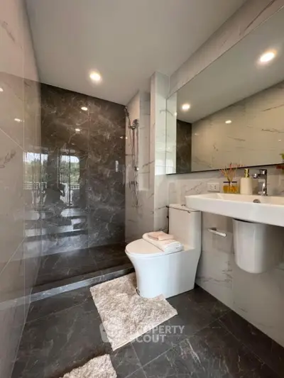 Luxurious modern bathroom with sleek marble tiles and elegant fixtures