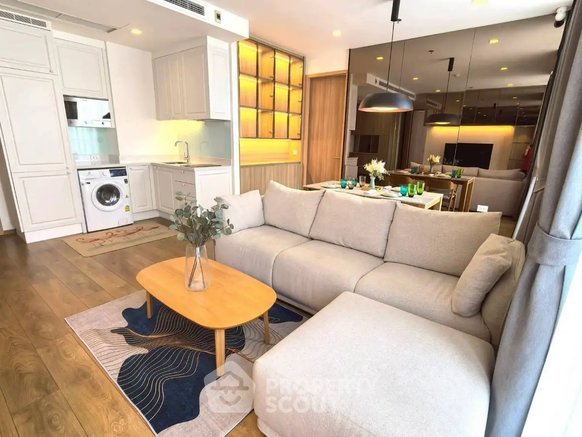 Modern open-plan living room with stylish kitchen and cozy seating area