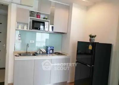 Modern compact kitchen with sleek cabinetry and appliances