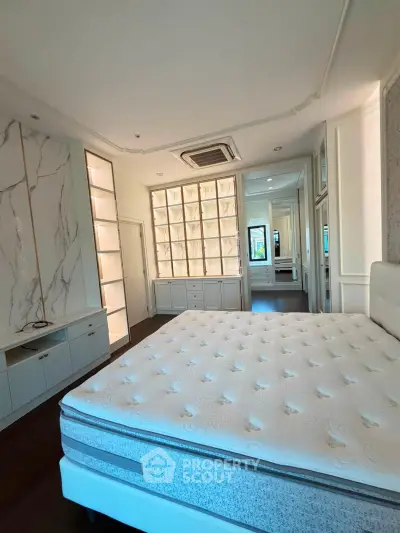 Luxurious bedroom with elegant built-in storage and plush mattress, perfect for modern living.