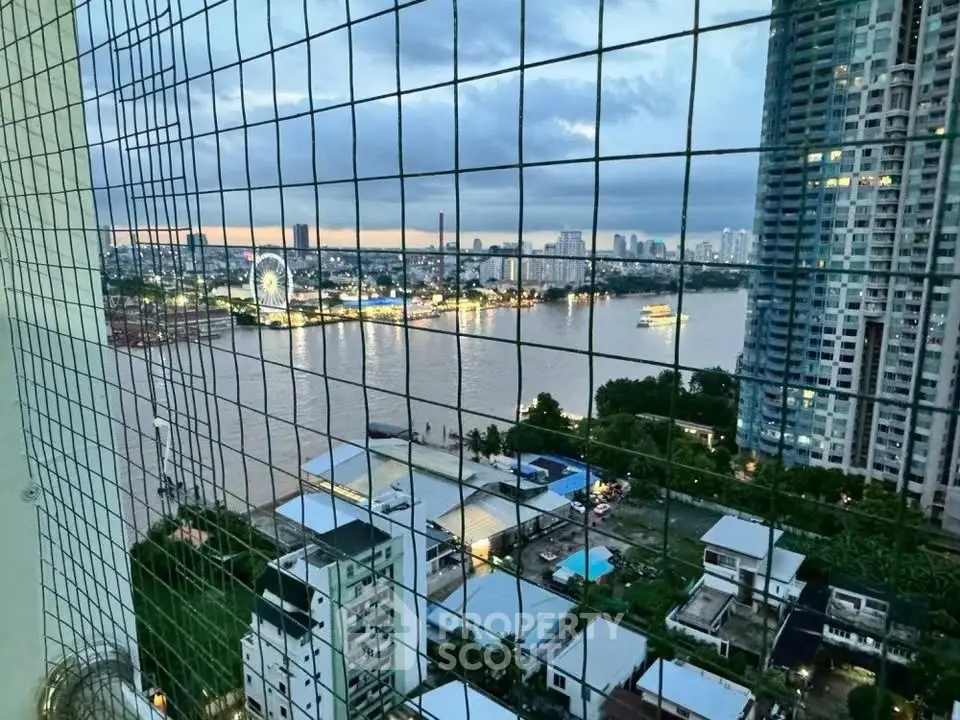 Stunning river view from high-rise apartment balcony at sunset, showcasing city skyline and waterfront attractions.