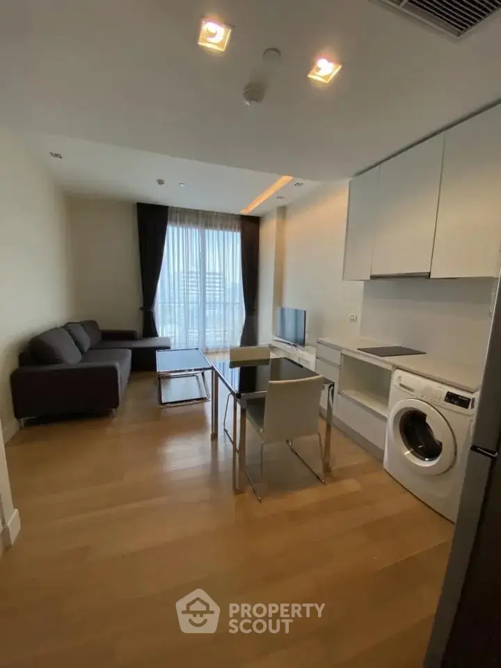 Modern living room with sleek furniture and in-unit washing machine, perfect for urban living.