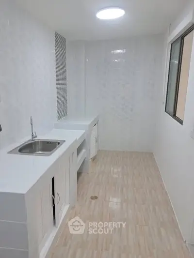 Modern kitchen with sleek white countertops and ample storage space