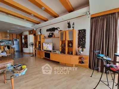 Spacious living room with wooden accents and modern entertainment center