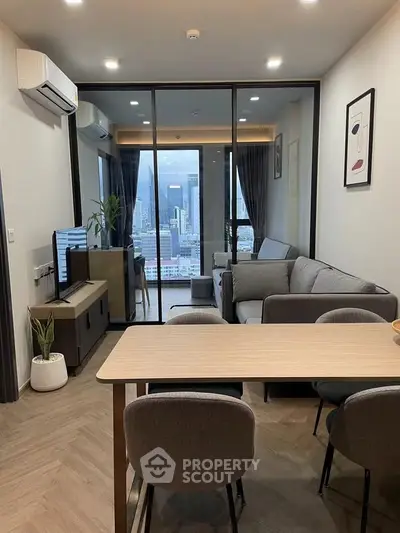 Modern living room with city view, featuring sleek furniture and stylish decor.