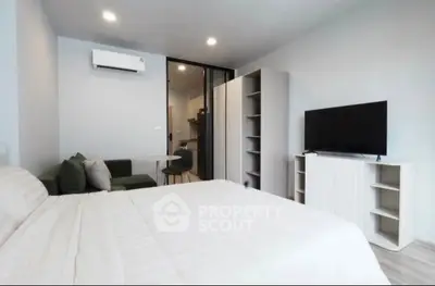 Modern studio apartment with cozy living area and sleek furniture