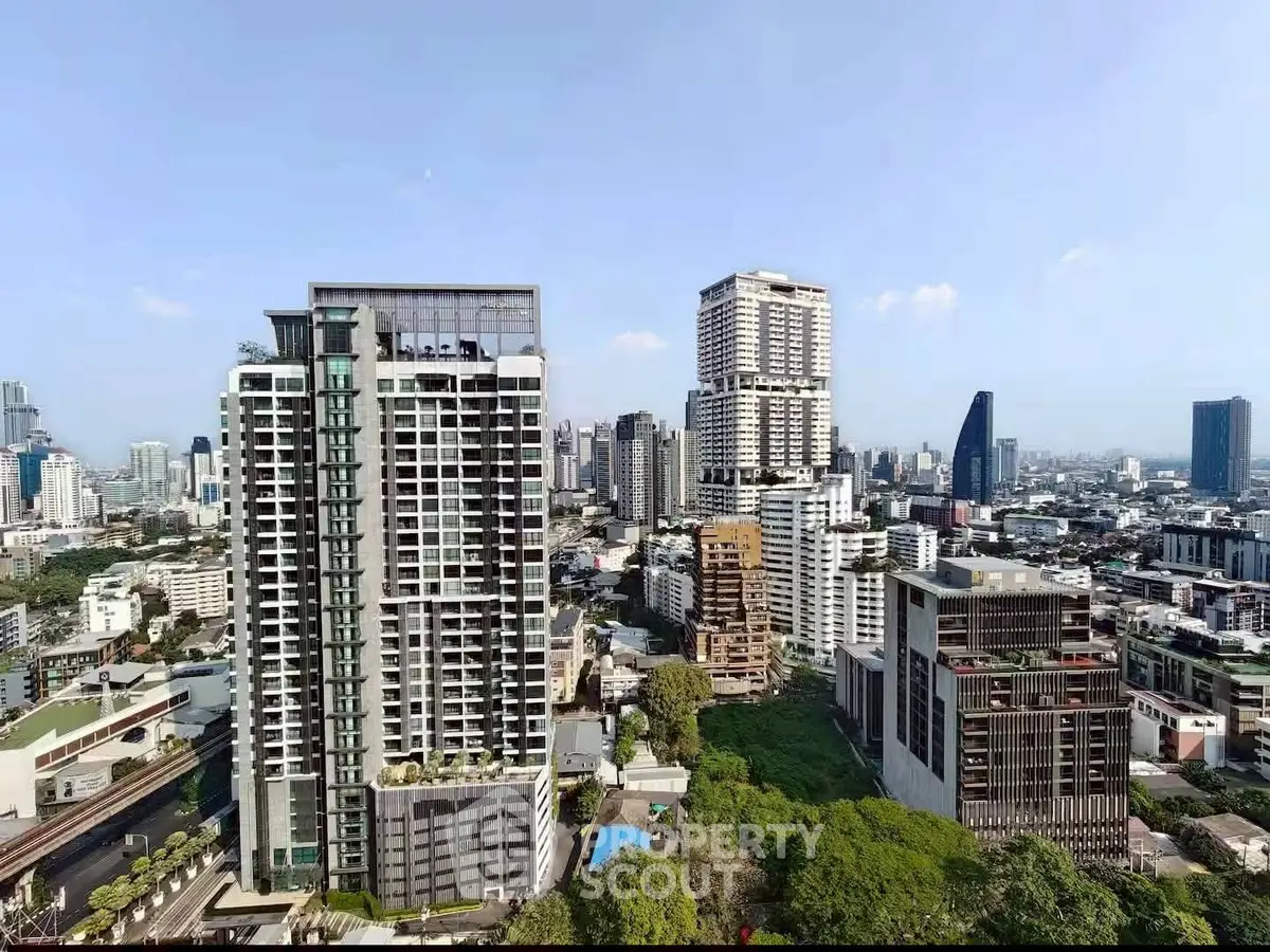Stunning cityscape view showcasing modern high-rise buildings and lush greenery in a vibrant urban setting.