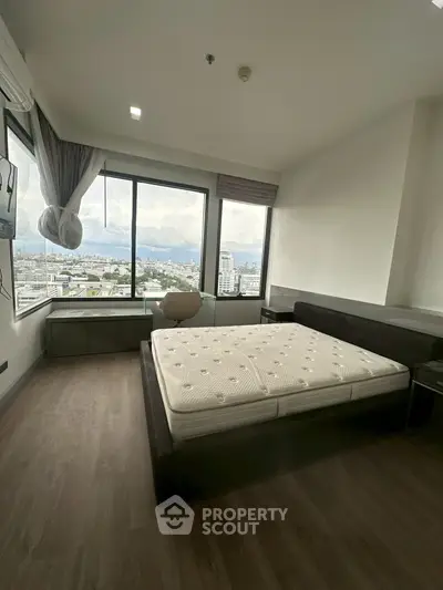 Spacious bedroom with stunning city view and modern furnishings
