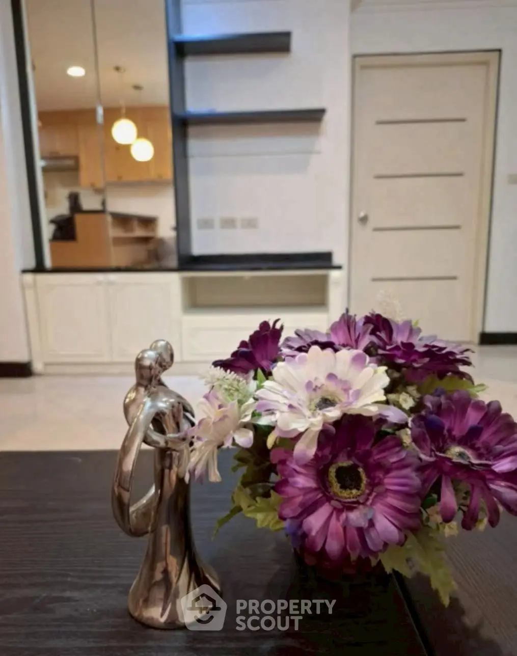 Stylish interior with elegant decor and vibrant flowers, showcasing modern living space.