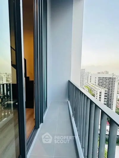 Modern high-rise balcony with city view, perfect for urban living.