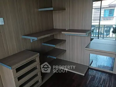 Modern wooden storage room with shelves and drawers, featuring a sleek design and ample space.
