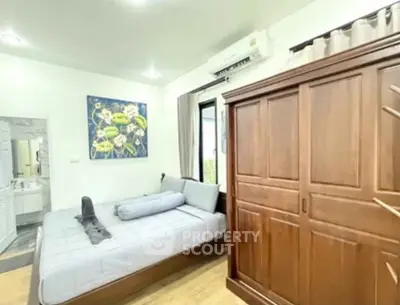 Cozy bedroom with wooden wardrobe and modern decor